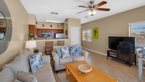 a living room with a couch and a tv at Palms D7 in Santa Rosa Beach