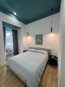 een slaapkamer met een groot bed en een blauw plafond bij Plan B B&B in Napels
