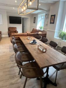 a large wooden table and chairs in a room at Fleece Cottage in Kendal