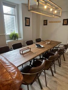 a conference room with a large wooden table and chairs at Fleece Cottage in Kendal