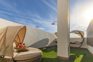 d'une terrasse avec une table et des chaises sur gazon. dans l'établissement Living4Malaga City Views Terrace, à Malaga