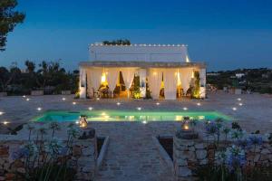 a villa with a swimming pool at night at Tenuta del Lauro in Locorotondo