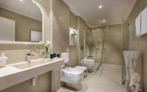 a bathroom with a sink and a toilet and a shower at Luxor e Cairo The Beach Resort in Lido di Jesolo