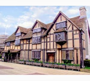 a large building with windows on a street at Bright modern apartment, Shipston-on-Stour in Honington