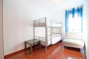 ein Zimmer mit zwei Etagenbetten und einem Tisch in der Unterkunft Global Properties, Apartamento con piscina en playa Corinto in Sagunt + 37 Fotos