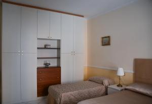 a bedroom with two twin beds and a dresser at Pagina Storica di Napoli in Naples