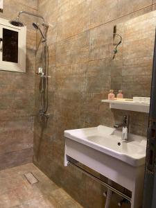 a bathroom with a sink and a shower at ALULA WINTER in AlUla