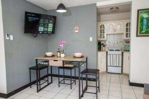 a kitchen with a table and stools in a room at Ocho Rios Sandcastles Resort on the beach 1 bedroom Apartment on the Beach in Ocho Rios