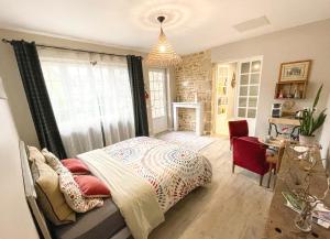 a bedroom with a bed and a chandelier at Suite privative terrasse in Alençon