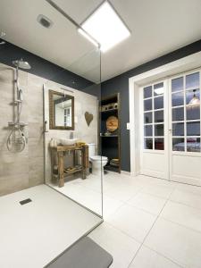 a bathroom with a shower and a glass door at Suite privative terrasse in Alençon