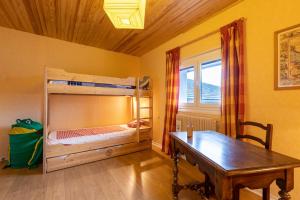 a room with a desk and a bunk bed and a table at Carols in Font-Romeu-Odeillo-Via
