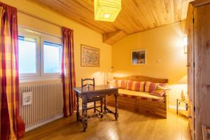 a bedroom with a bed with a desk and a window at Carols in Font-Romeu-Odeillo-Via