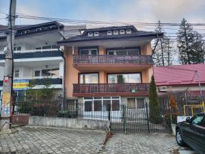 a house with a balcony on the side of it at Vila Maya Predeal in Predeal