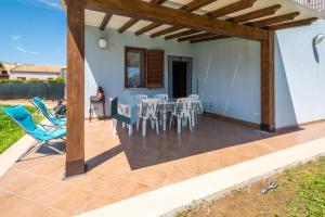 a patio with a table and chairs on it at Villa Pietro in Lascari