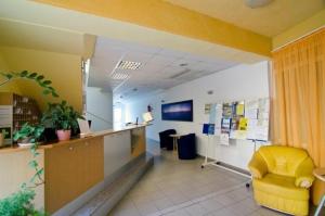 an office with a waiting room with a yellow chair at SpaRelax Apartman Zalakaros in Zalakaros