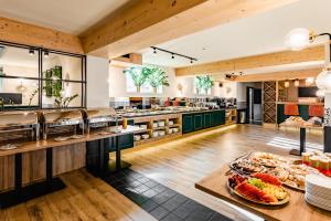 a restaurant with a buffet of food on display at Aparthotel Diamond SPA Family in Białka Tatrzanska