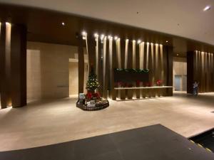 a christmas tree in the middle of a lobby at Anggun Residence Modern Suites with Netflix 3Mins to Monorail KL Near KLCC in Kuala Lumpur