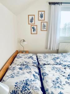 a bedroom with a bed with blue and white sheets at Ubytování U Křivánků in Telč