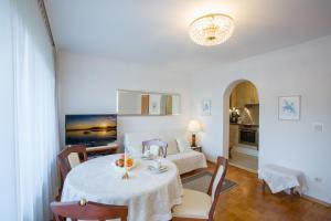 a living room with a table and a room with a bed at Landhaus Alpenblick in Garmisch-Partenkirchen