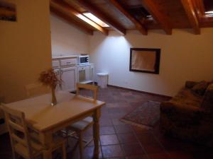 a living room with a table and a kitchen at Agriturismo Al Navile in Malalbergo
