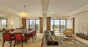 a living room with a table and a dining room at Hyatt Regency Birmingham in Birmingham