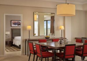 a dining room with a table and chairs and a bedroom at Hyatt Regency Birmingham in Birmingham