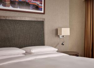 a hotel room with a bed and a lamp at Hyatt Regency Birmingham in Birmingham
