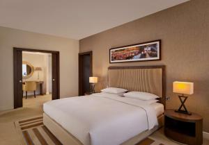 a bedroom with a large white bed with two pillows at Hyatt Regency Birmingham in Birmingham