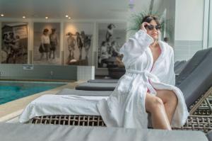 a woman sitting on a bed in a towel at Hyatt Regency Birmingham in Birmingham