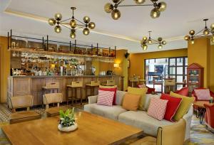 a living room with a couch and a bar at Hyatt Regency Birmingham in Birmingham