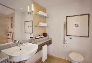 a white bathroom with a sink and a toilet at Hyatt Regency Birmingham in Birmingham