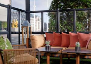 a patio with a couch and tables and windows at Hyatt Regency Birmingham in Birmingham