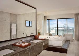 a bathroom with a tub and a large window at Hyatt Regency Birmingham in Birmingham
