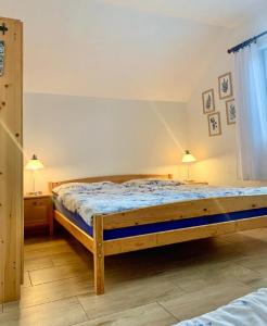 a bedroom with a wooden bed in a room at Ubytování U Křivánků in Telč