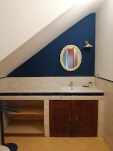 a bathroom with a sink and a blue wall at Poggio Delle Palme in Campobello di Licata