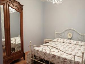 a bedroom with a bed and a mirror at Poggio Delle Palme in Campobello di Licata