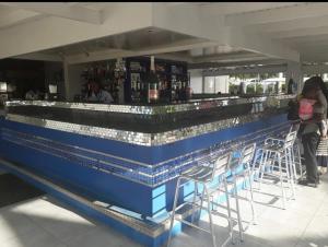 a bar with a blue counter with stools around it at SugaLove Villa 30 Flamboyant Ave in Saint James