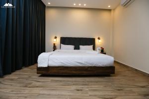 a bedroom with a large bed with black curtains at Sofia Pyramids Hotel in Cairo