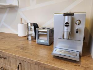 a kitchen counter with a refrigerator and a coffee maker at Kuuse 4 Apartment in Haapsalu