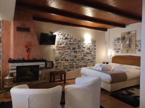 a bedroom with two beds and a stone wall at Prasino - Galazio in Mouresi