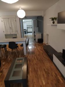 a living room with a table and chairs in a room at Apartamento Jarauta 50 in Pamplona