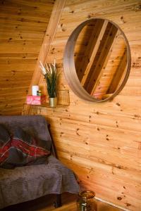 a mirror on a wooden wall in a room at Domek Poniwiec Mała Czantoria in Ustroń