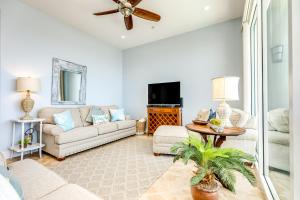 a living room with a couch and a tv at Diamond Beach Resort Seawall Stunner in Galveston