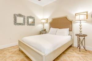 a bedroom with a large white bed and two lamps at Diamond Beach Resort Seawall Stunner in Galveston