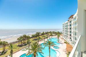 a view of the beach from the balcony of a resort at Diamond Beach Resort Seawall Stunner in Galveston