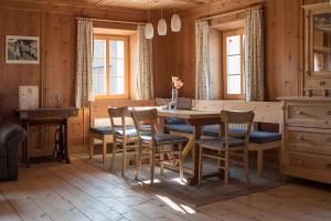 uma sala de jantar com uma mesa de madeira e cadeiras em Marhof Pustertal em Anras