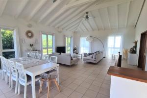 聖馬丁島的住宿－Villa Picaflor, Friar's Bay，用餐室以及带桌椅的起居室。