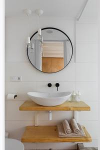 W łazience znajduje się umywalka i lustro. w obiekcie Passage Apartment w Iwano-Frankiwsku