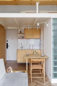 a kitchen and dining room with a wooden table at Passage Apartment in Ivano-Frankivsʼk