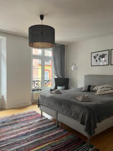 a bedroom with a bed and a large window at Stilvolle Altstadtwohnung mit 2 Schlafzimmern in Koblenz